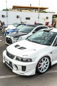 Close-up of high-performance cars parked in an urban setting during daytime.